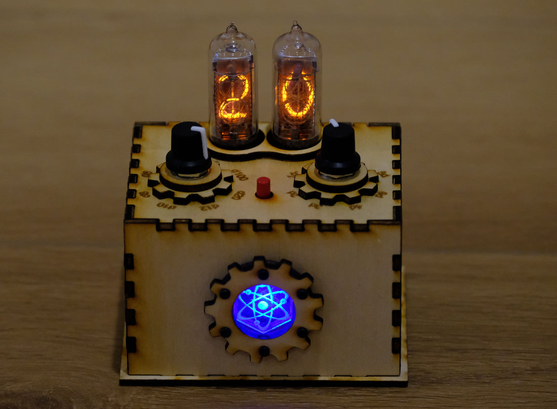 A front view of the Quantum Entropy Engine: Expedition. The unit is in its laser cut wooden enclosure and is powered on. The center acrylic chamber is glowing from the internal LED. The Nixie tubes are powered on and are glowing orange in color - a 20 is displayed on the display tubes.