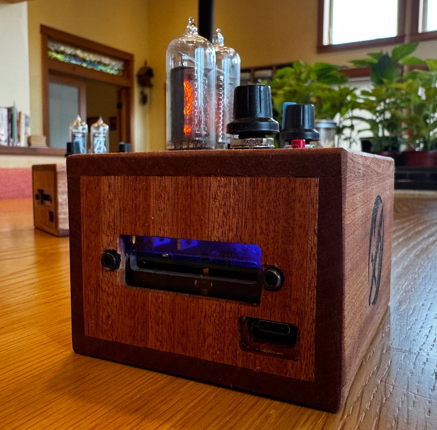 Custom mahogany enclosure for a quantum entropy engine. An acrylic window lets the user view the internal circuit components.