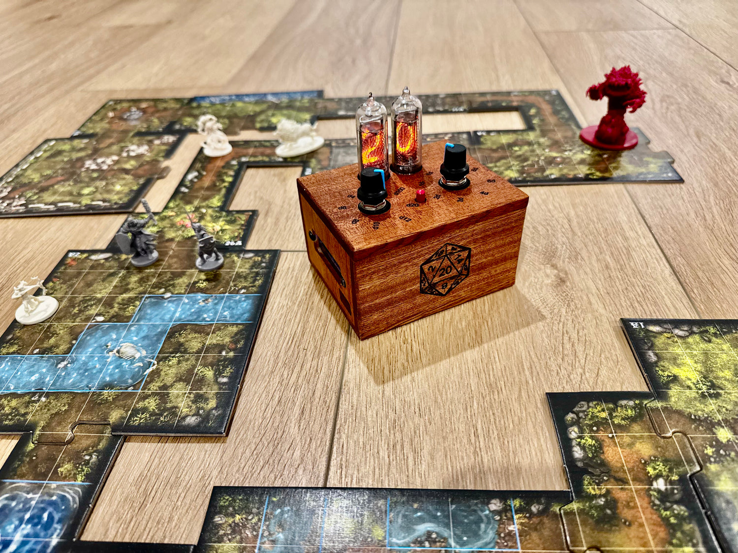 A board game setup with a quantum entropy engine displayed at the center. The wooden box is a deep vibrant mahogany, with a laser engraved 1d20 on the front.