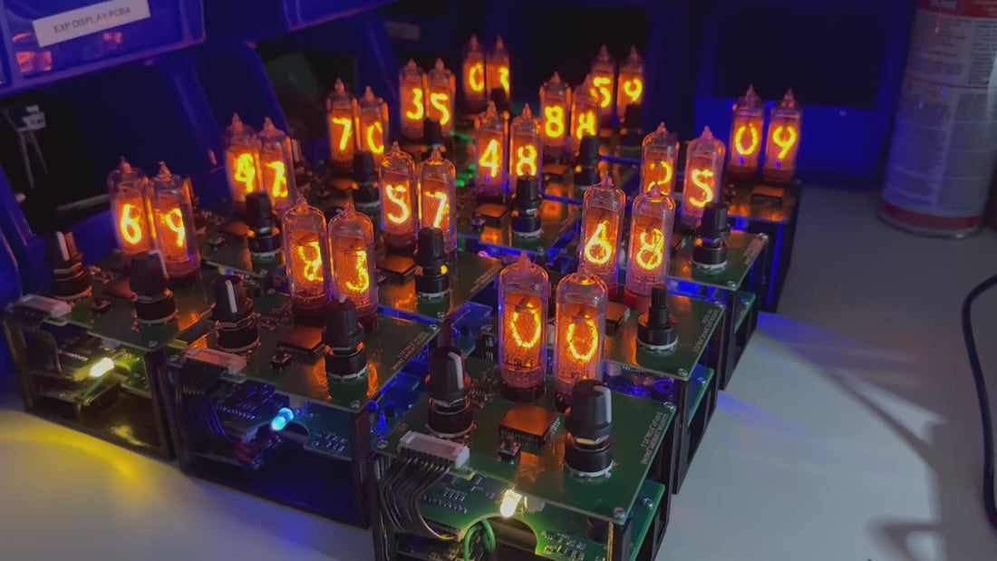 A video depicting multiple quantum entropy engines sitting on a laboratory bench setting. The units are fully assembled minus the outer enclosure, allowing the viewer to see the printed circuit board components. The Nixie tubes are shown continuously cycling through random numbers.